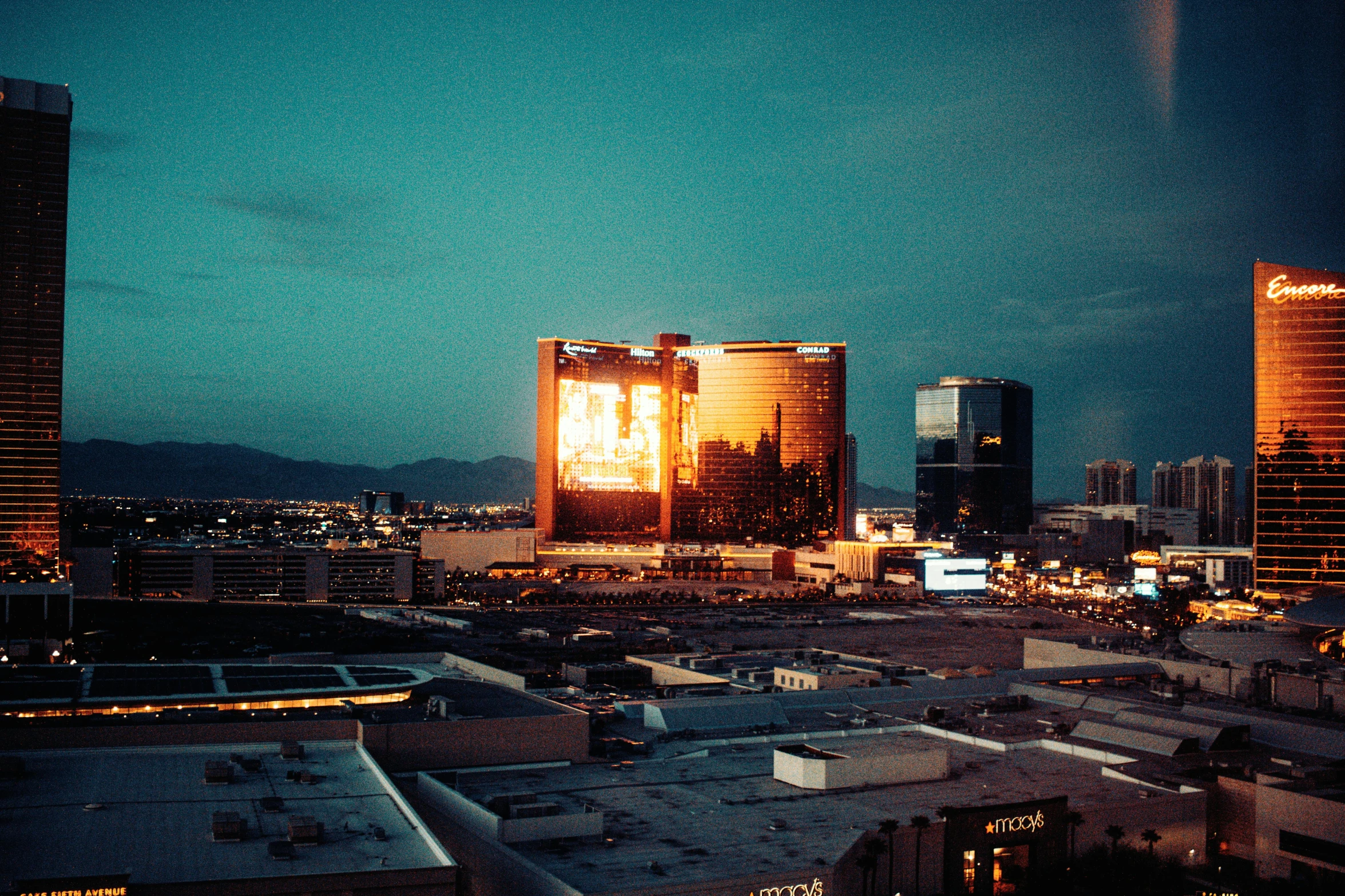 an aerial view of buildings at night and with tall buildings