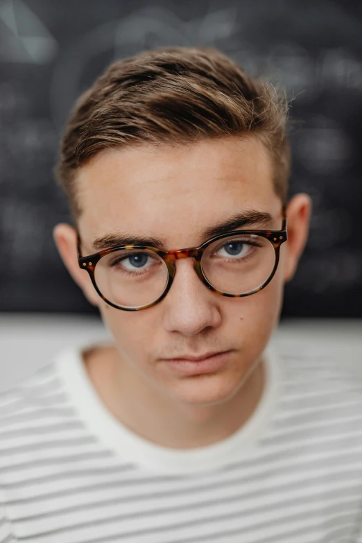 a man wearing glasses and a striped sweater