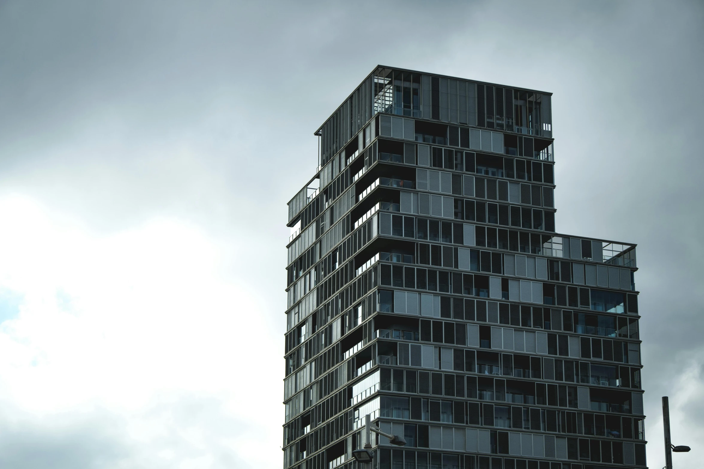 a tall building with windows that looks like they have balconies on them