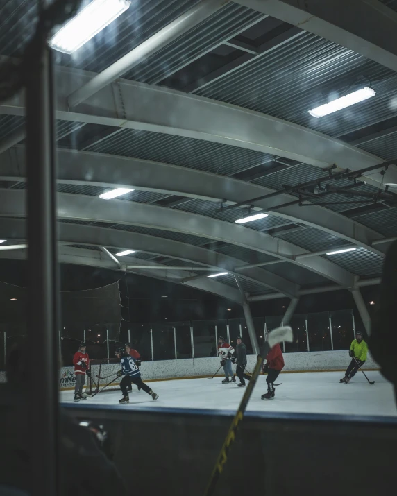 a group of people skate in a rink