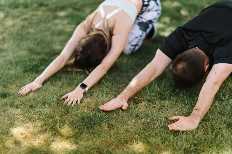 a man laying on his back on top of grass