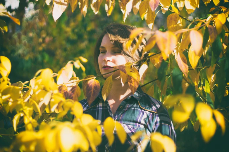 a  is hiding her head through the leaves