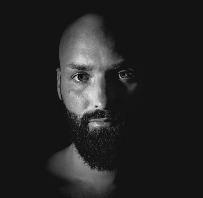 black and white portrait of a bald man with beard