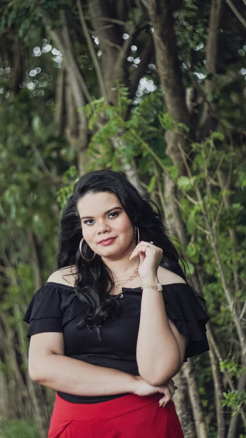 a woman with long black hair and wearing a dress