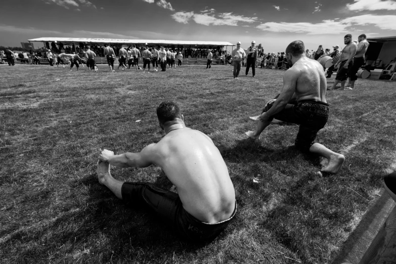 there are many people standing in the grass at a festival