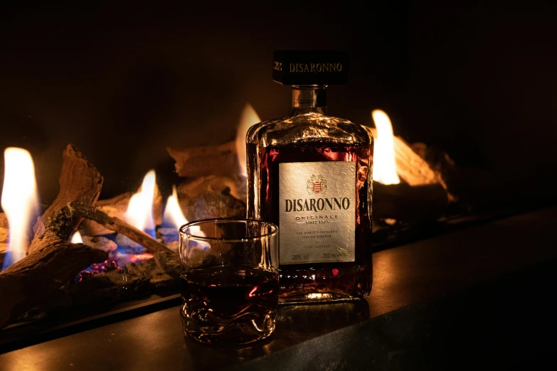 this is a bottle of liquor sitting next to an open fireplace