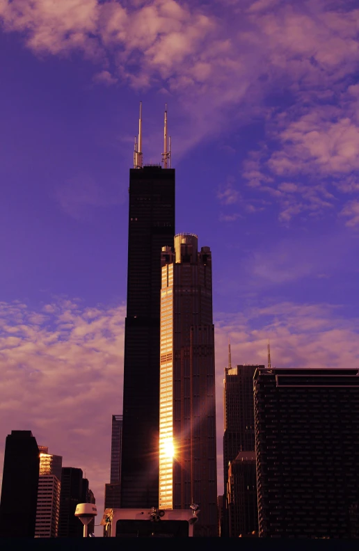 a city skyline with skyscrs at dusk