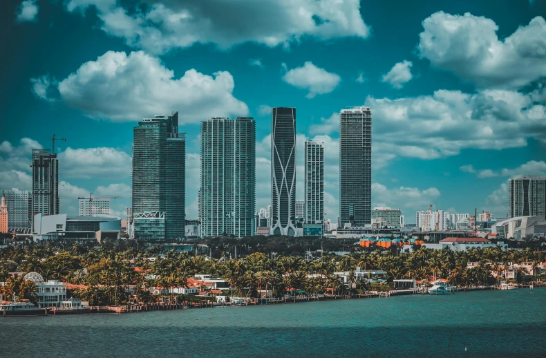 large buildings are set along the coast by water