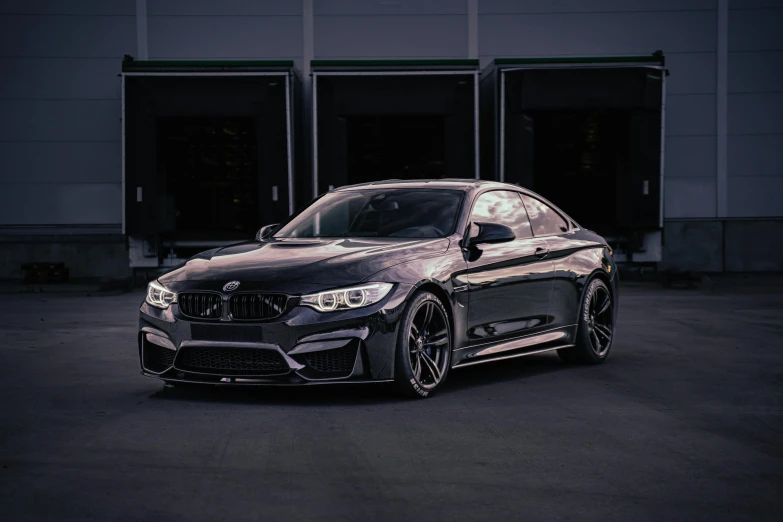 the grey bmw gt4 is parked in front of a building