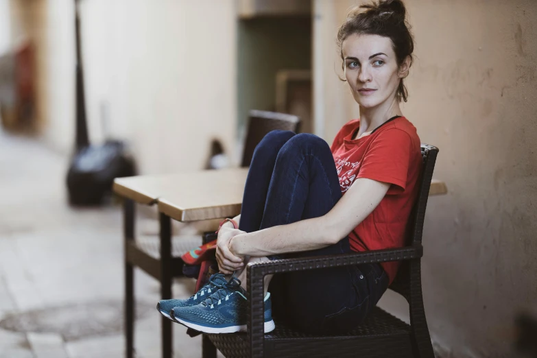 a woman sitting in a chair next to a table