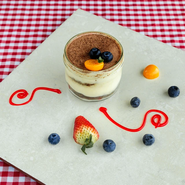 a dessert in a glass on a  board