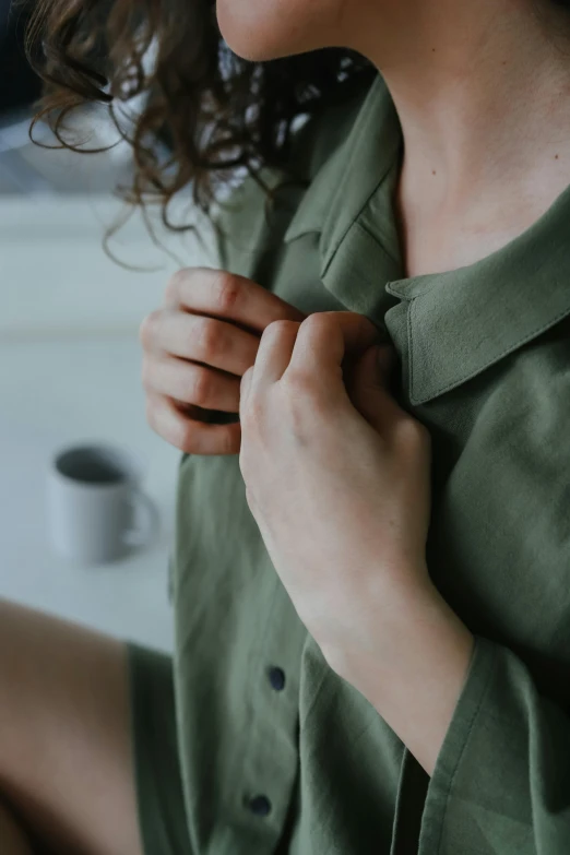 a woman is tying her dress with a ribbon