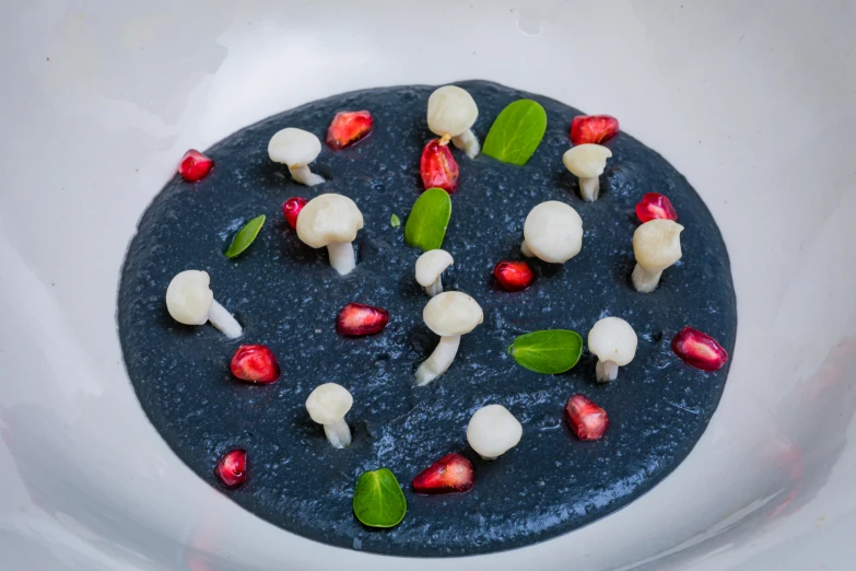 a white plate topped with food next to red and green leaves