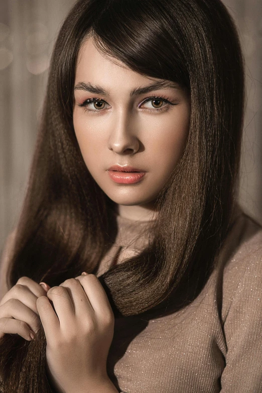 a woman with long hair is straightening her hair