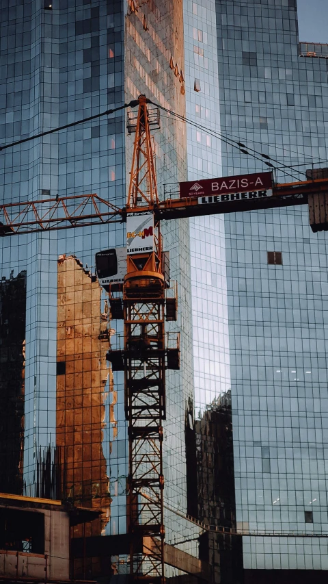 some very tall buildings reflected in the windows