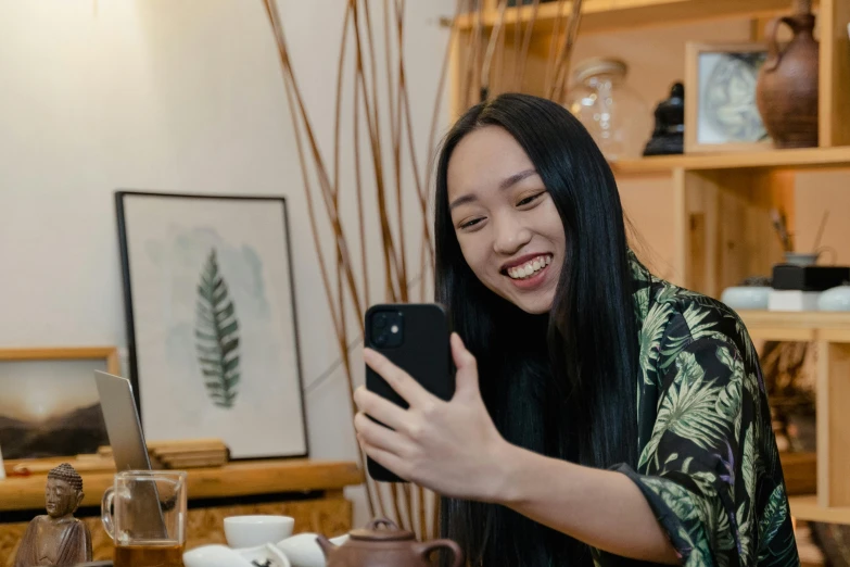 a woman taking a selfie with a cell phone