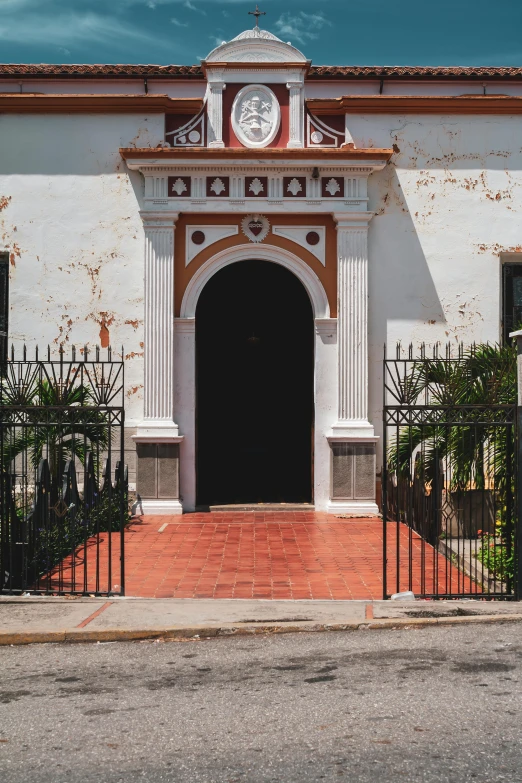 a small church is painted with a white and tan color