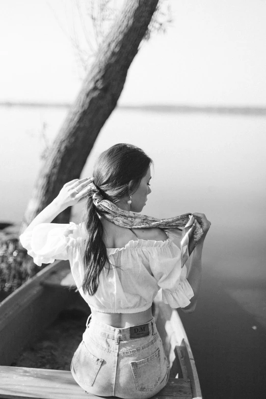 a young lady sits on the end of a boat