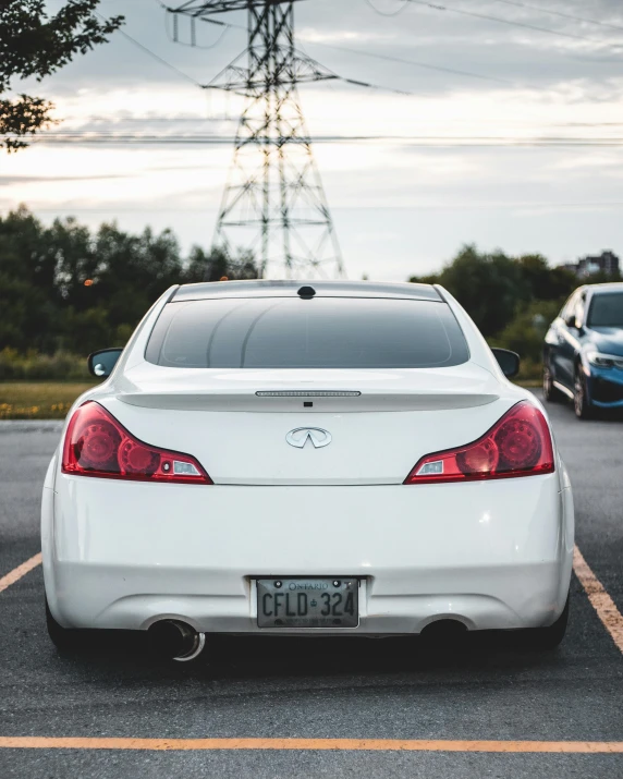 a white car is parked in a parking lot