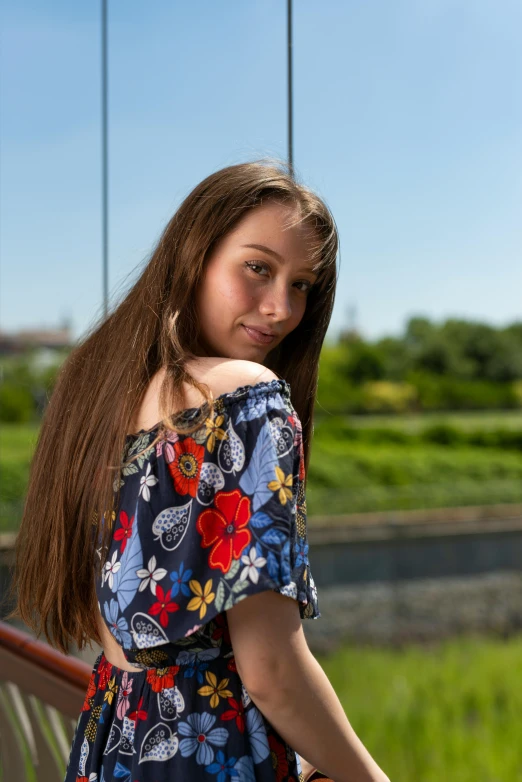 a beautiful woman standing with her long hair in a ponytail