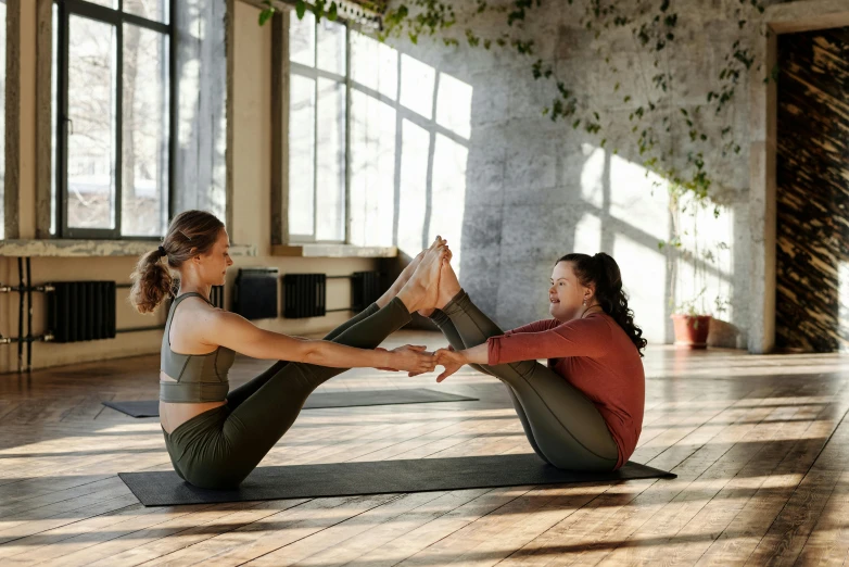 two women working out on their yoga mats