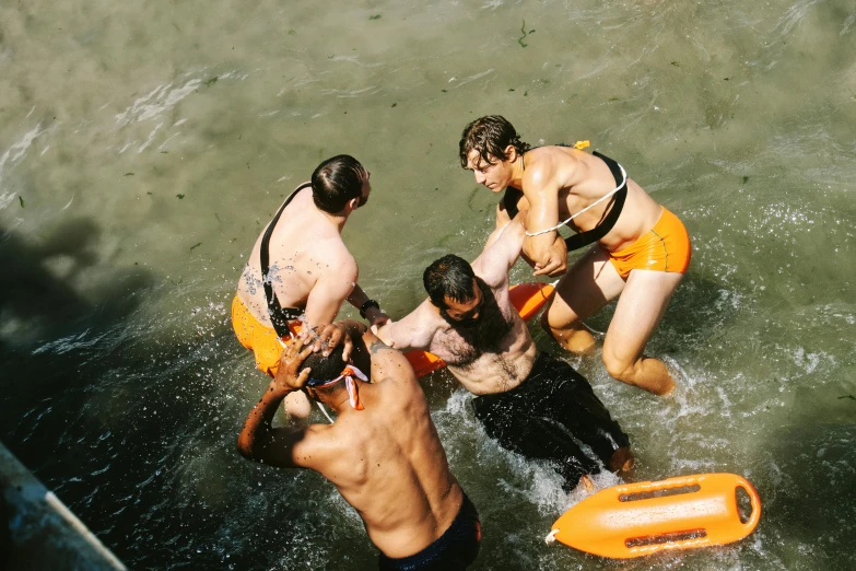 three people standing in the water with an raft