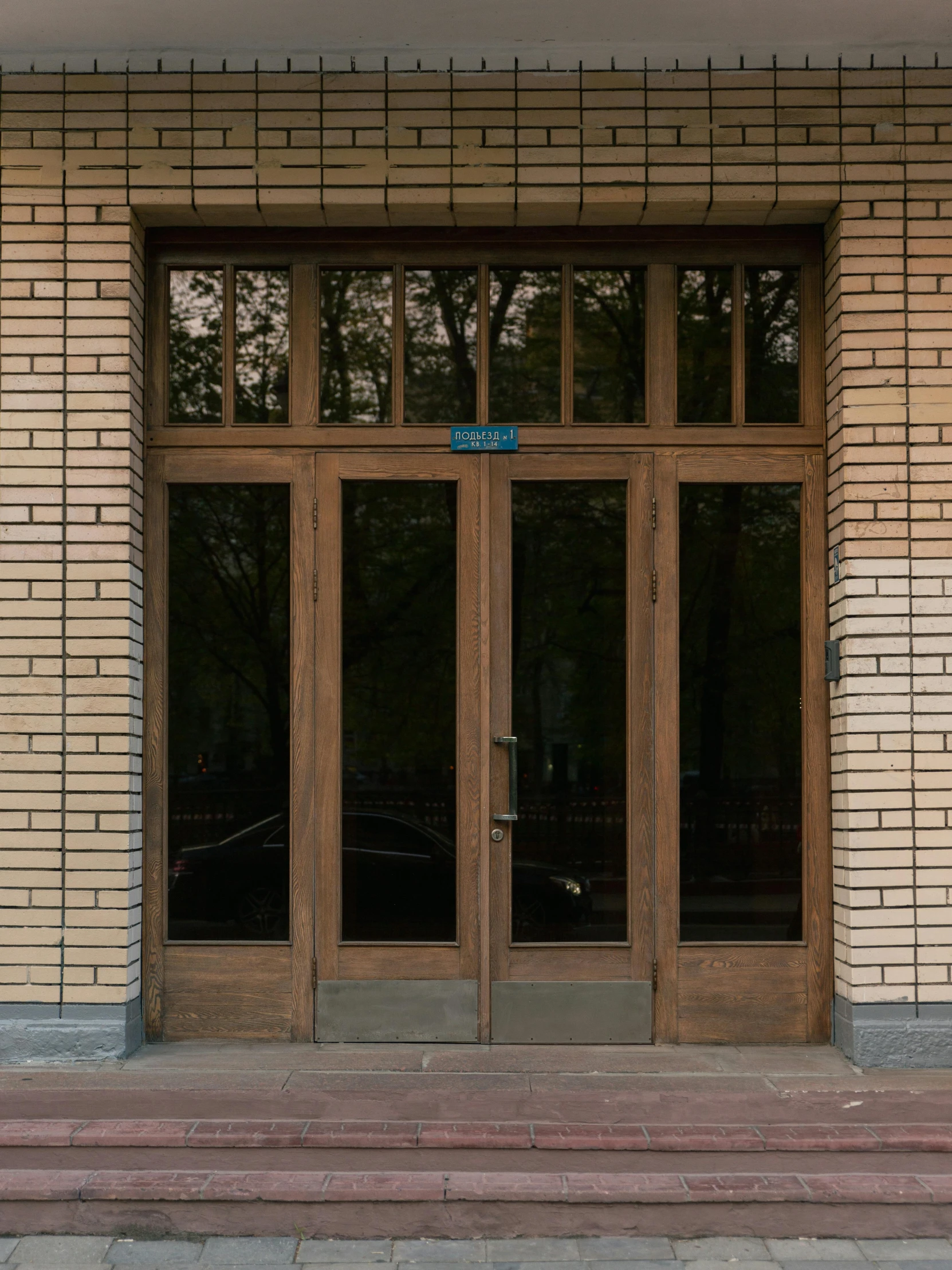 an entrance to a brick building with a street sign on it