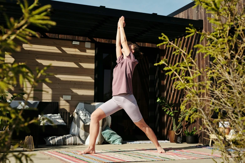 woman standing on her belly while doing yoga