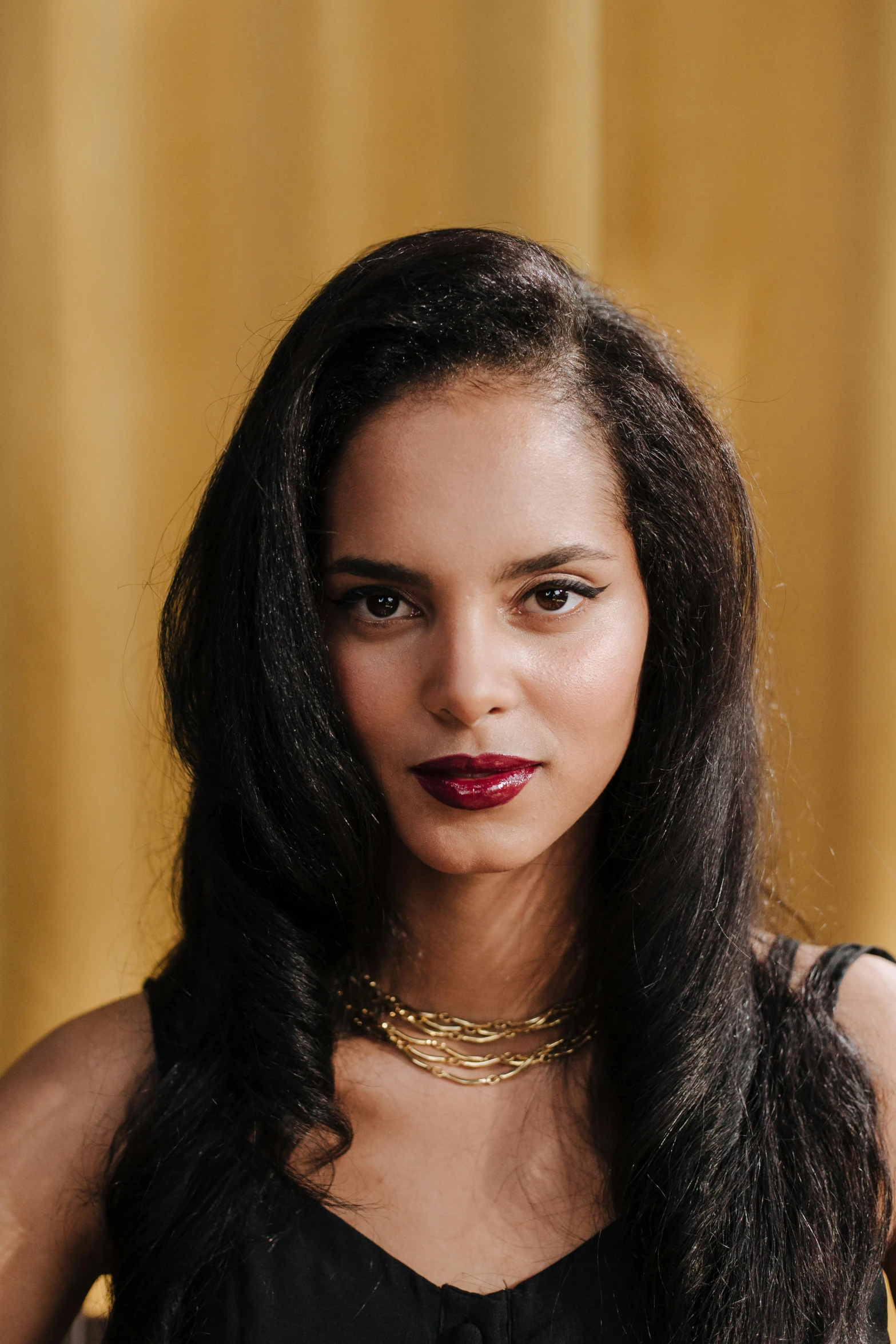 a woman with long black hair wearing a choker