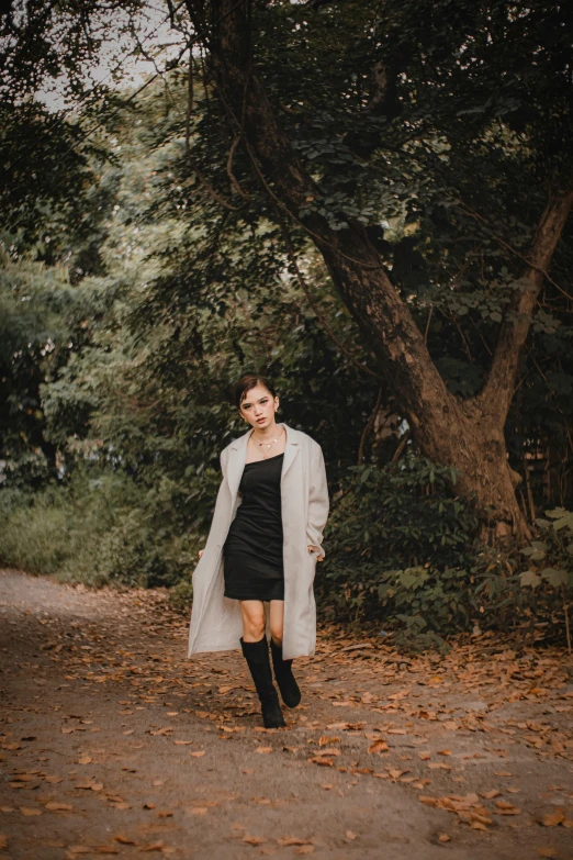 a girl in a black dress wearing long cardigan