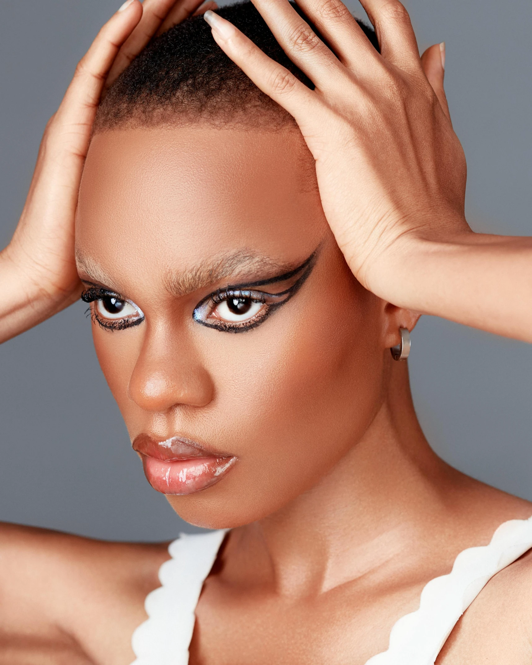 a woman wearing black make up and eyeliners