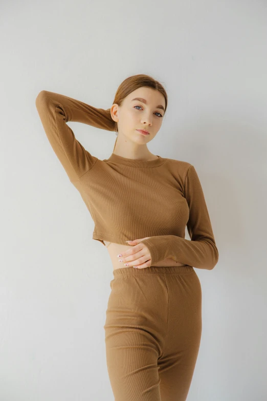 a beautiful woman posing in a brown outfit