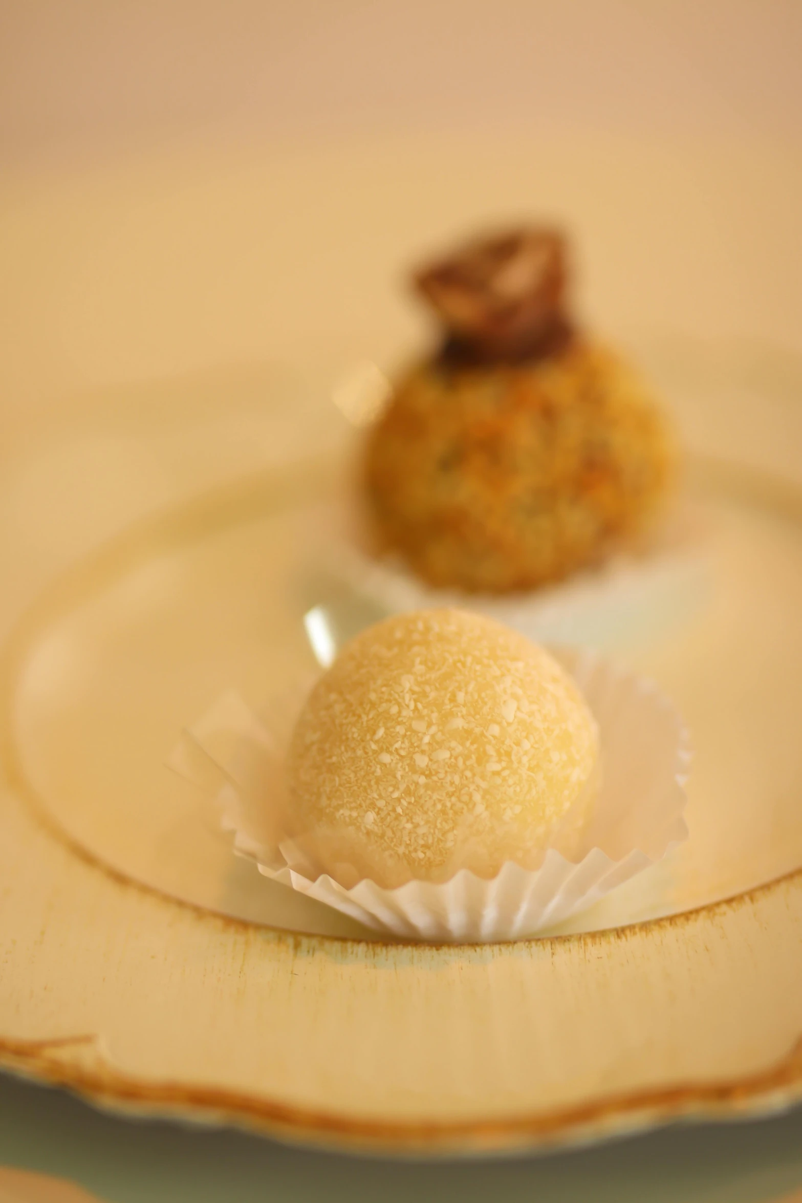 a little round dessert sitting on top of a white plate