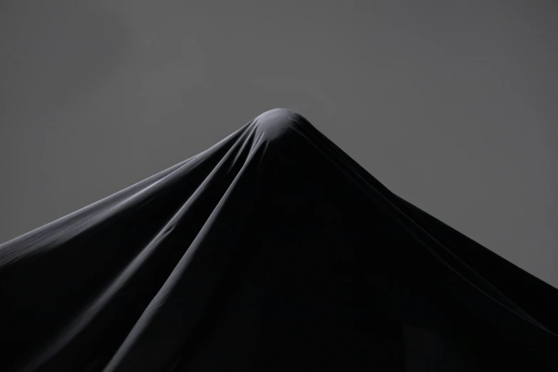 an image of a black umbrella in the dark