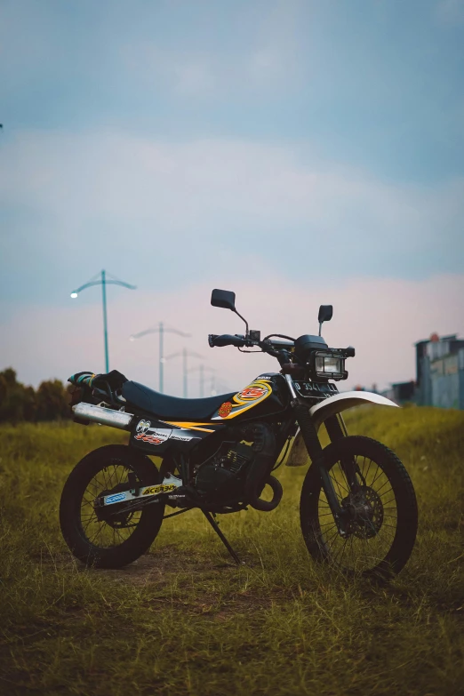 a motorcycle is parked in the grass near a road