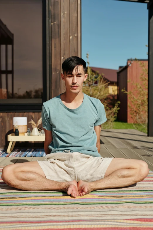 man on a towel is sitting in a pose