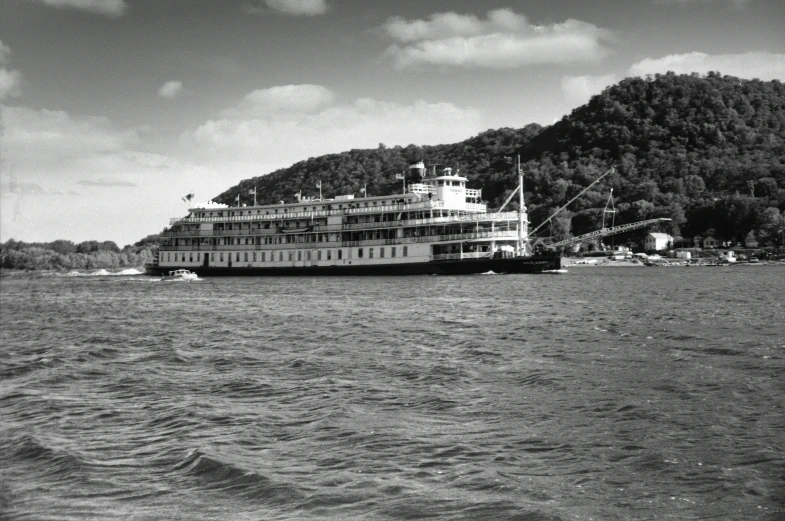 a ship on the water surrounded by mountains