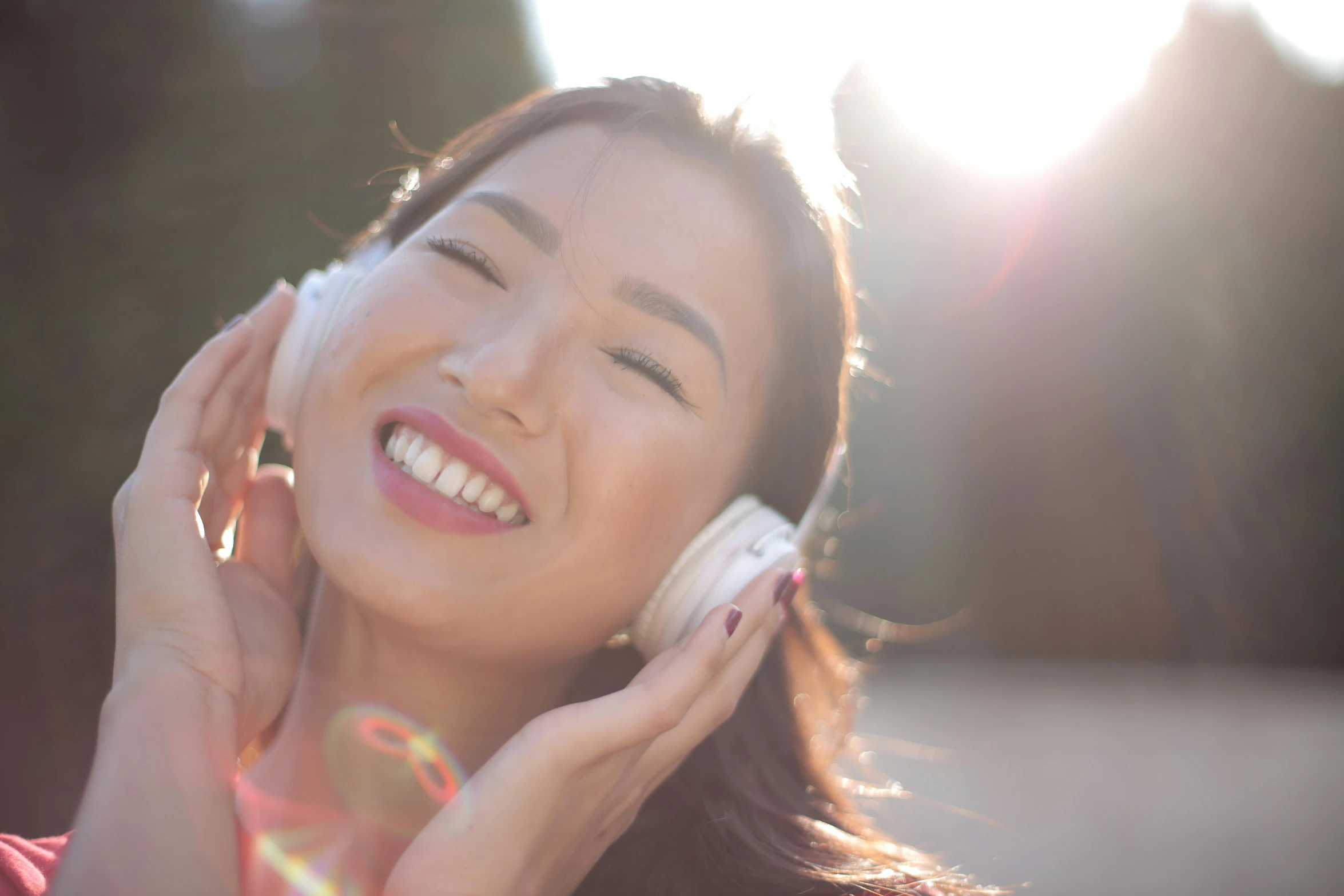 a woman talking on a cell phone while smiling