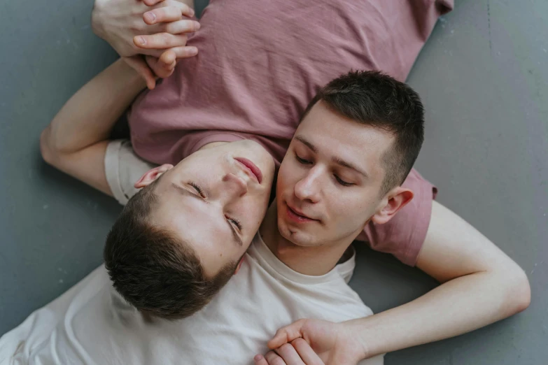 a man and woman lie down on the ground