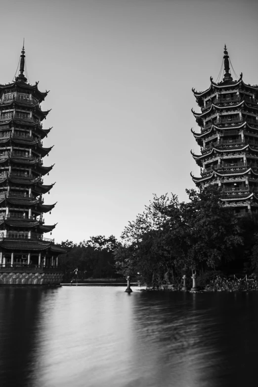 an ancient building next to another one in the water