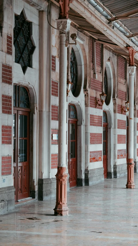 the inside of a building with pillars and windows