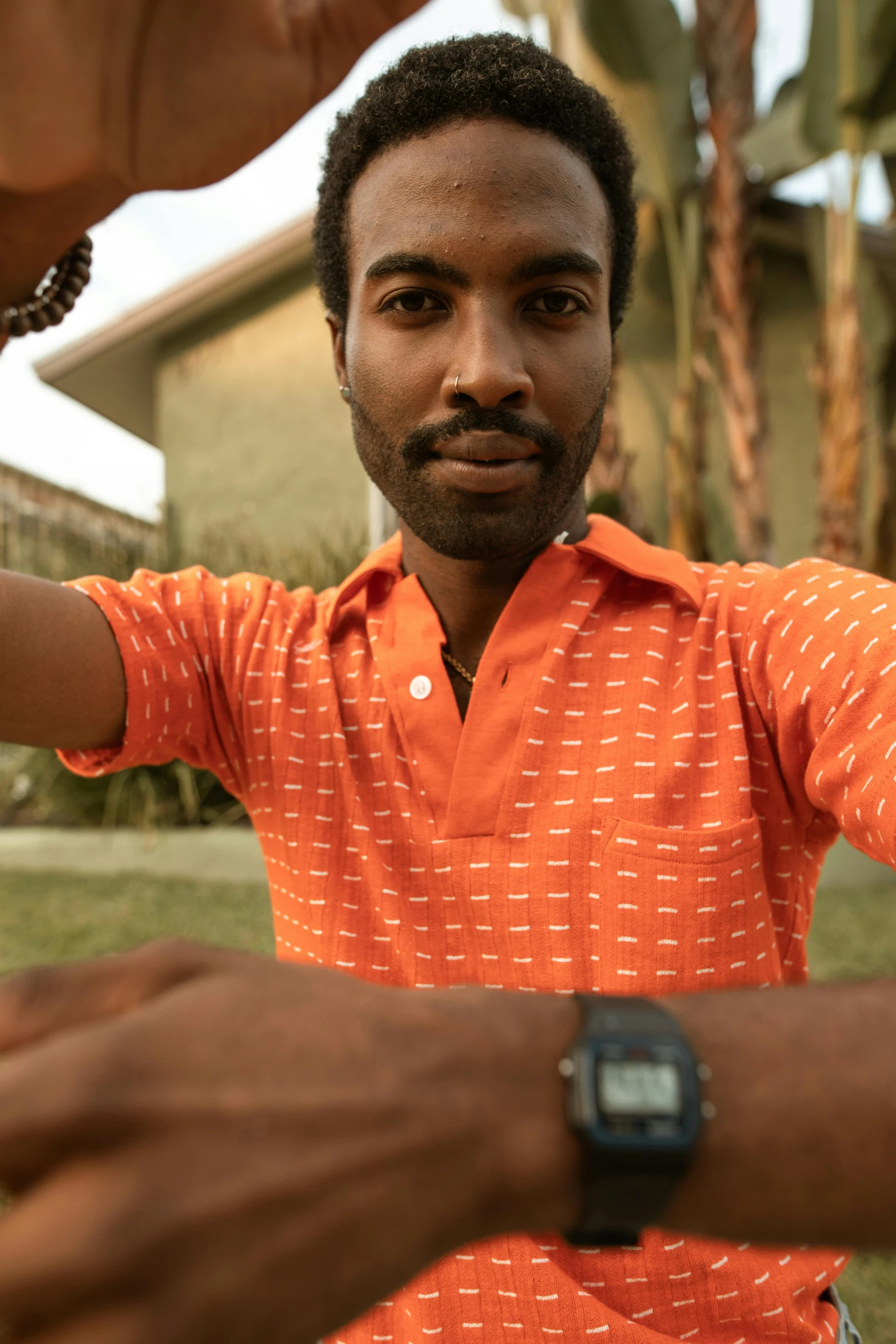 a man looking down at his watch with one hand