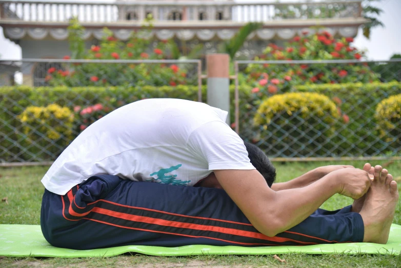 man sitting on a blanket with his back to the ground