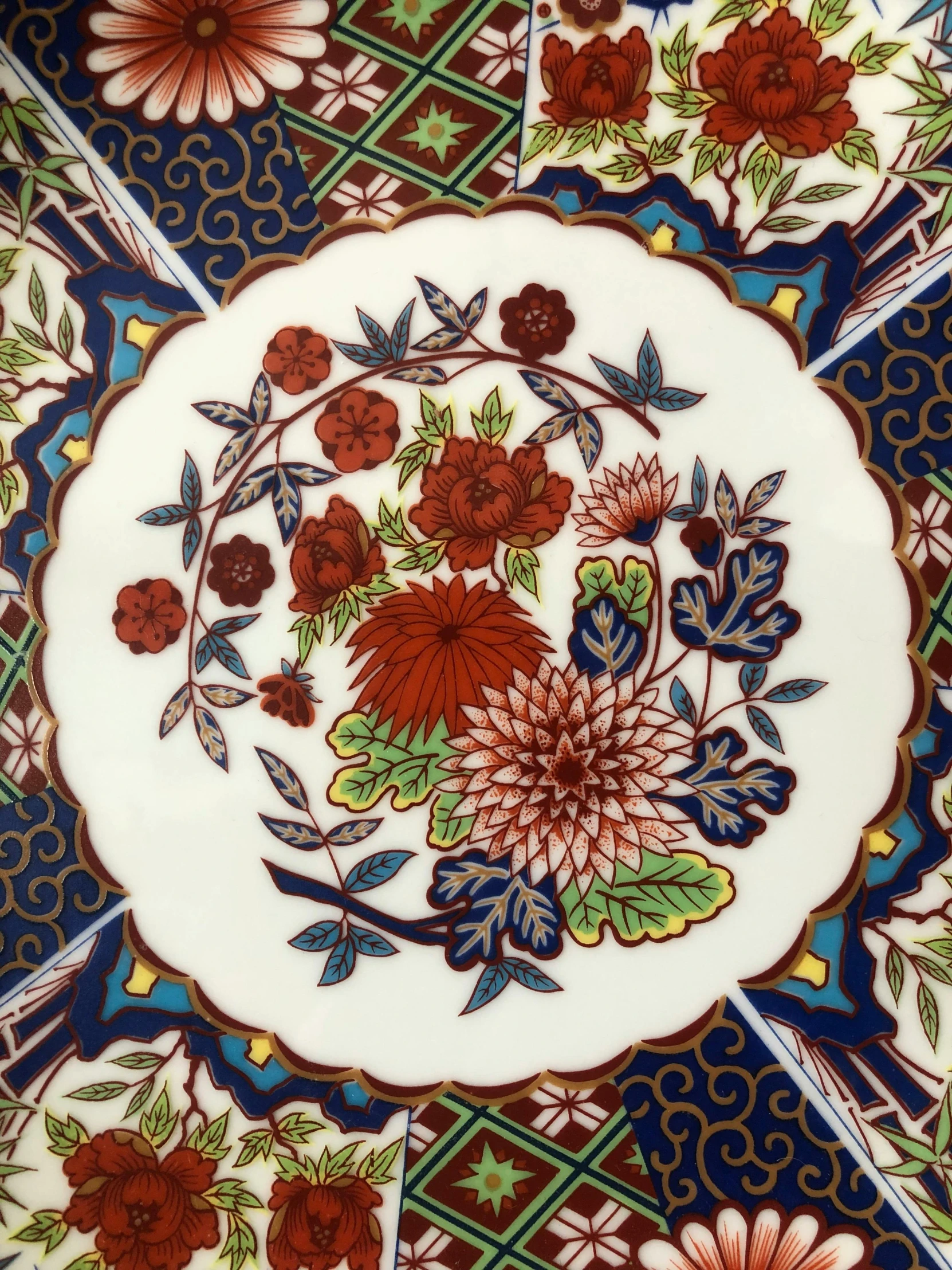 decorative flowered plate on colorful tiles with elaborate patterns