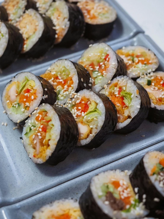 a tray with trays of sushi with different toppings