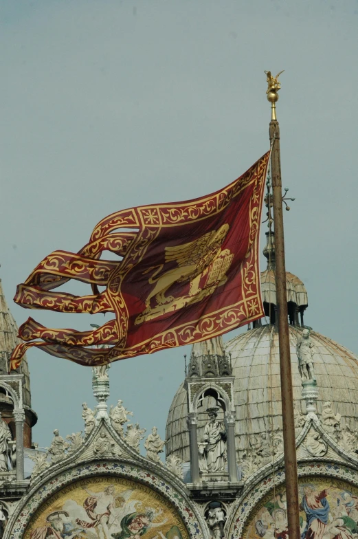 the flag in front of the elaborately painted building