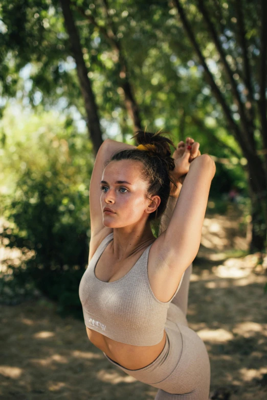 a woman in the park doing a hand stand