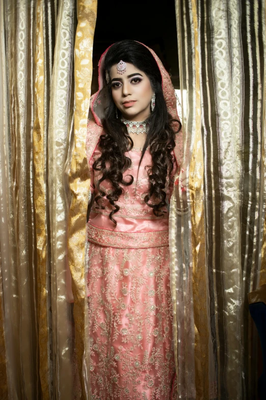 a woman with makeup on is looking out from behind a curtain