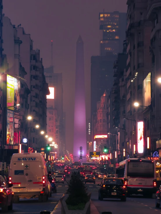 several vehicles in the road on a foggy night