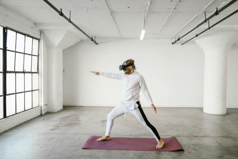 a woman in white doing yoga on a pink mat